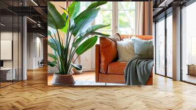 Horizontal image of a vibrant living room featuring a large tropical houseplant the giant white bird of paradise strelitzia nicolai with copy space Wall mural