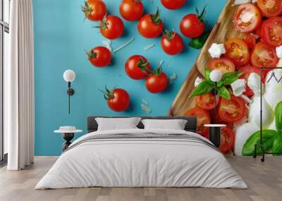 Italian flag created with mozzarella cheese cherry tomatoes and green basil on a wooden cutting board against a blue background top view copy space Wall mural