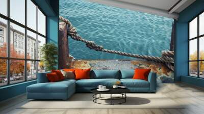 Metal mooring with ropes in the harbor creating a picturesque scene with ample copy space image Wall mural