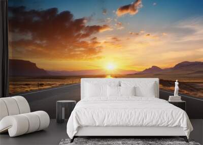 Scenic road through landscape with a sunset view, portraying a concept of road travel adventures with a car. Background features copy space image. Wall mural