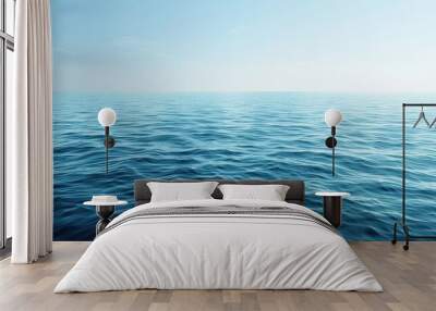 Serene view of calm ocean waves in a clear blue sea with a tranquil blue water background and ample copy space image Wall mural