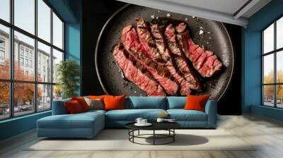 Sliced grilled top blade steak on a plate Organic beef Black background Top view. Copy space image. Place for adding text and design Wall mural