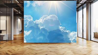 Sunny summer sky with light curly white clouds floating in a bright blue background symbolizing heaven and infinity ideal as a copy space image Wall mural