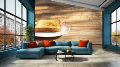 Toast on a plate positioned in the lower left corner of a wooden background with copy space image Wall mural