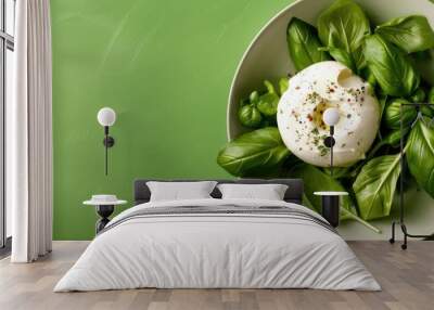 Top down view of a tasty burrata salad in a bowl on a green table with room for adding text in the copy space image Wall mural