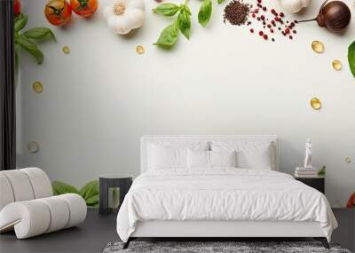 Top view of a clean paper background with a food cooking border consisting of fresh green basil cherry tomatoes and garlic cloves The ingredients are ready for preparing a meal with ample copy space Wall mural