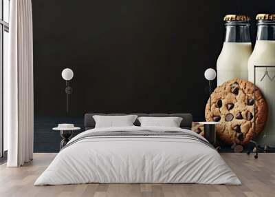 Two bottles of milk alongside chocolate chip cookies on a dark background with copyspace Wall mural