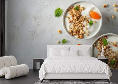 Web banner featuring two bowls of natural yogurt with apricot pieces granola and pine nuts on a light background including copy space image Wall mural