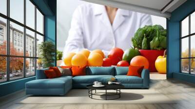 Woman seated at table with dish of veggies Wall mural