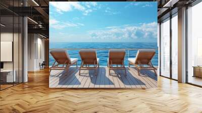 Three lounge chairs on a wooden deck overlooking the ocean on a sunny day Wall mural