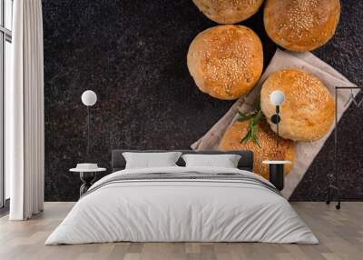 Homemade whole grain brown buns with sesame seeds on rustic background. Healthy artisan bread. Wall mural