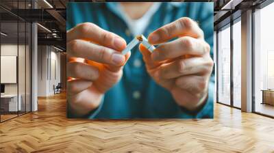 Broken cigarette in hands symbolizing quitting smoking Wall mural