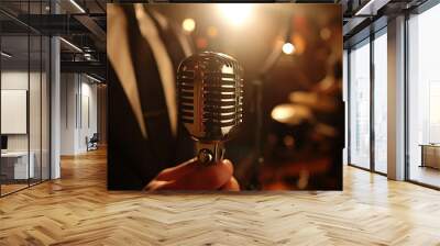 Close-up of singer hand holding a retro microphone on of a jazz or rock 'n' roll club stage during a concert. Energy and atmosphere of a live music performance. Wall mural