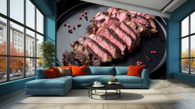 Sliced grilled rib eye beef steak beef marbled rare, on plate, on old dark rustic background Wall mural