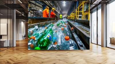 Two men in orange work on a conveyor belt filled with bottles at an outdoor recycling facility Wall mural