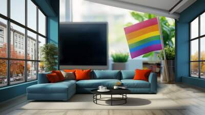 Office desk with an LGBT flag displayed prominently, symbolizing workplace diversity, inclusion, and support for LGBTQ+ rights. Values of equality, acceptance, and respect Wall mural