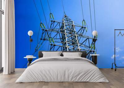 Power line, metal electric poles with wires, bright blue sky. Wall mural