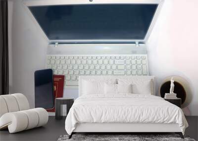 white laptop, smartphone, russian passport and  cup of coffee on a light background Wall mural