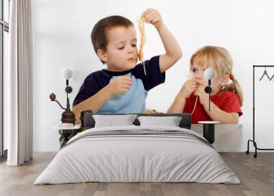 Two kids eating pasta with their hands Wall mural