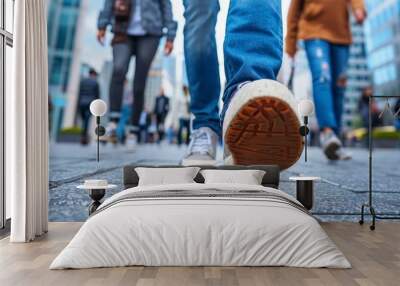 Diverse urban crowd s legs in shoes walking on city street with urban background Wall mural