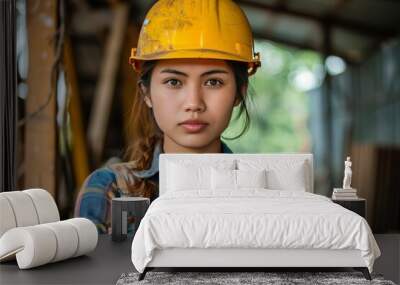 Female technician maintaining and servicing robotic arm in an industrial factory environment Wall mural