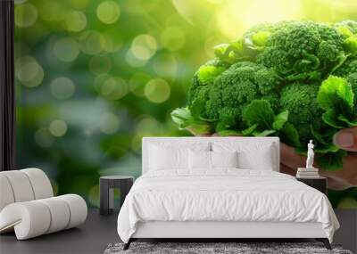 Hand holding fresh broccoli floret on blurred background with space for text placement Wall mural