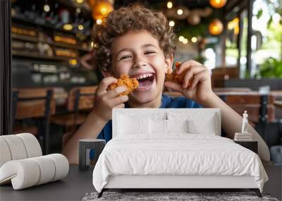 Happy preteen enjoying fried chicken in restaurant with blurred background and copy space Wall mural