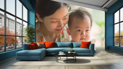 Mother and daughter playing happily with a toy  heartwarming close up with soft lighting Wall mural