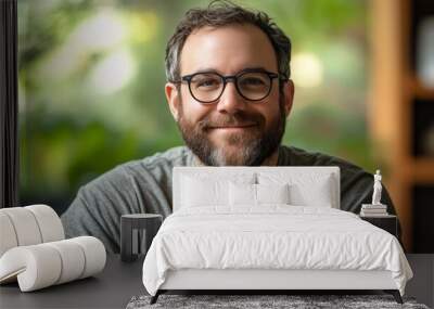 Portrait Of Smiling Man With Glasses, Indoor Casual Headshot With Green Bokeh Background Wall mural