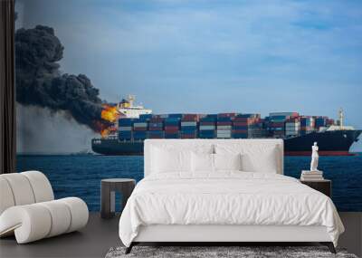 Cargo ship engulfed in flames in the middle of the ocean with rising smoke. Wall mural