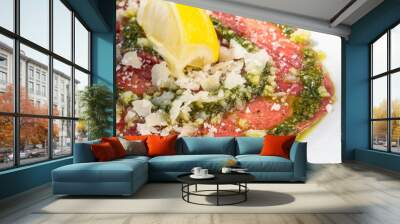 carpaccio-Fresh Sliced raw beef meat with leaf lettuce on the ta Wall mural