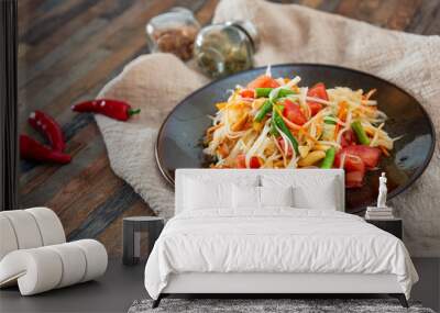 Traditional Thai food papaya salad prepared with fine slices of papaya, tomatoes, green beans and peanuts. Wall mural