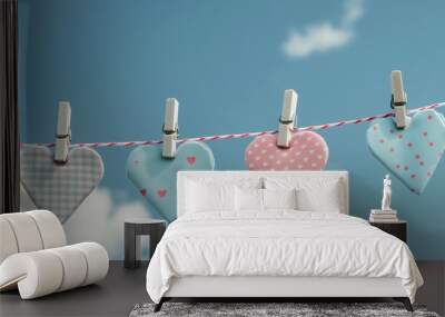 blue and pink fabric hearts hanging on the clothline rope with blue sky and clouds in the background.  Wall mural