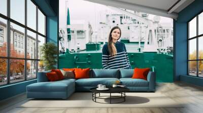 Elegant cutie brunette in stylish fashion clothes on a barge in the seaport. Candid portrait of a person. Wall mural