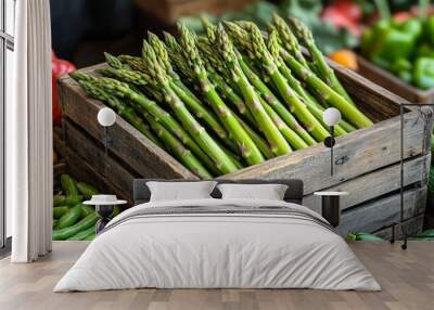 Fresh asparagus displayed in a wooden crate at a farmer's market, showcasing local produce and vibrant colors. Wall mural