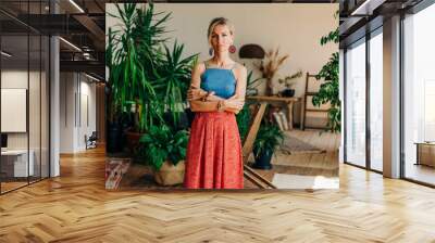 Portrait of gorgeous blonde woman standing in authentic living room interior Wall mural