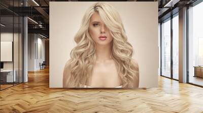 Blonde european woman with curly hair, beauty model on beige isolated Wall mural