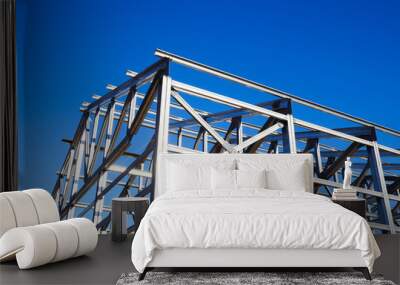 metal frame of the roof against the blue sky Wall mural