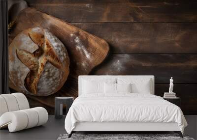 Freshly baked bread on a wooden table with flour.  Wall mural