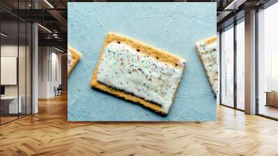 Pop tarts panorama. Poptart toaster pastry on a blue background, overhead flat lay shot, panoramic banner Wall mural