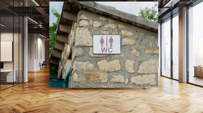 Sign toilet door old stone heart outdoor wood wooden vintage, concept retro tree in sun and sanitation facility, window historic. Europe countryside ancient, Wall mural