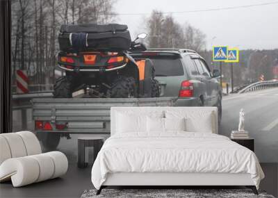 Transportation of technical equipment for extreme active sports, AWD car with a single-axle trailer on the asphalt highway road Wall mural