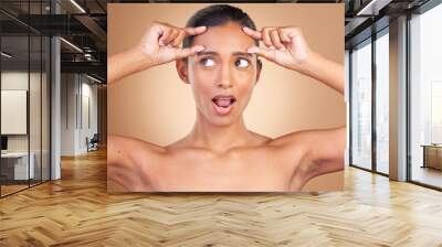 Beauty health, surprise and woman forehead wrinkles with a female squeeze face with shock. Isolated, studio background and cosmetic change of a model holding clean skin for plastic surgery Wall mural