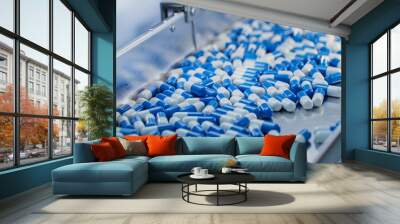 Blue Capsules are Moving on Conveyor at Modern Pharmaceutical Factory. Tablet and Capsule Manufacturing Process. Close-up Shot of Medical Drug Production Line. Wall mural