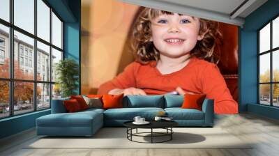 cute little girl playing on her tablet Wall mural