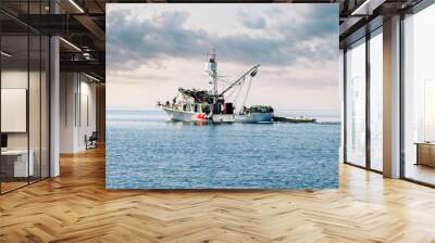 fishing boat under a beautiful sunset Wall mural