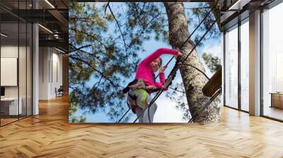 pretty girl in a park of tree climbing Wall mural