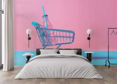 A shopping cart with a pink drink bottle and blue straw on a summery blue background Wall mural