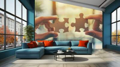 Closeup of two hands holding puzzle pieces connecting together on blurred background Wall mural