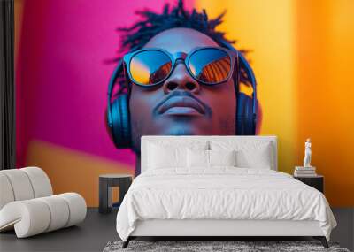 A man wearing sunglasses and headphones is looking at the camera Wall mural